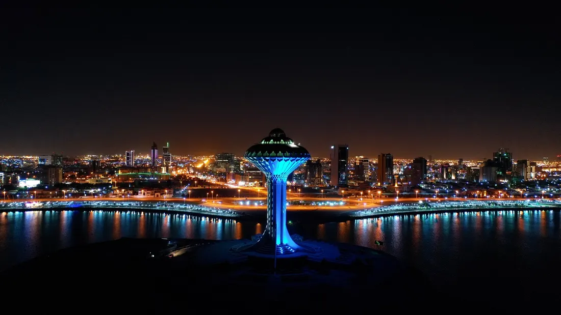 The Al Khobar Water Tower lit at night, with the city behind it